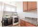Functional laundry room with washer, dryer, and storage space at 29431 N 23Rd Dr Dr, Phoenix, AZ 85085