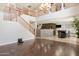 An open-concept living space with a staircase, kitchen view, and hardwood floors at 29431 N 23Rd Dr Dr, Phoenix, AZ 85085