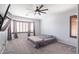 Main bedroom with a bay window with wooden shutters and a ceiling fan at 29431 N 23Rd Dr Dr, Phoenix, AZ 85085