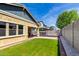 The well-maintained backyard includes lush green grass and a built-in bench for seating at 3023 E Arabian Dr, Gilbert, AZ 85296