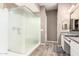 Bright bathroom featuring glass shower, double vanity, and modern tile flooring at 3023 E Arabian Dr, Gilbert, AZ 85296