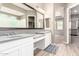 Bathroom with double vanity, spacious countertops and glass enclosed shower at 3023 E Arabian Dr, Gilbert, AZ 85296