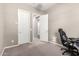 Bedroom with plush carpet, a desk, and multiple doorways for easy access at 3023 E Arabian Dr, Gilbert, AZ 85296