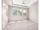 Neutral bedroom featuring recessed ceiling with fan, carpet flooring, and multiple windows at 3023 E Arabian Dr, Gilbert, AZ 85296