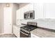 Well-appointed kitchen showcasing stainless steel appliances, white cabinets, and granite countertops at 3023 E Arabian Dr, Gilbert, AZ 85296