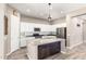 Bright open kitchen with stainless appliances, granite island, and white cabinets at 3023 E Arabian Dr, Gilbert, AZ 85296