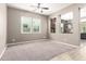 Bright living room boasts neutral walls, plush carpeting, tile flooring, and a decorative ceiling fan at 3023 E Arabian Dr, Gilbert, AZ 85296