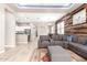 An open-concept living room featuring a comfortable gray sofa set, and a kitchen in the background at 3023 E Arabian Dr, Gilbert, AZ 85296