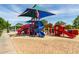 Community playground with slides and sun shades in a landscaped area near walking path at 3023 E Arabian Dr, Gilbert, AZ 85296