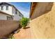 A narrow side yard with desert landscaping and a stucco wall provides privacy at 3023 E Arabian Dr, Gilbert, AZ 85296