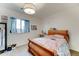 Cozy bedroom with plush carpeting, window, overhead lighting, and wooden bed frame at 3153 E Ivanhoe St, Gilbert, AZ 85295