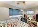 Bedroom featuring a comfortable bed, TV, and cozy seating area with a decorative ceiling fan at 3153 E Ivanhoe St, Gilbert, AZ 85295