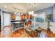 Bright kitchen with hardwood floors, an island with seating, and a glass table in the dining area at 3153 E Ivanhoe St, Gilbert, AZ 85295
