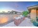Outdoor kitchen features brick surround, tile countertop, and stainless steel grill on a stone patio at 3153 E Ivanhoe St, Gilbert, AZ 85295