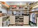 Custom walk-in closet with ample shelving, drawers, and organized hanging space for clothes and accessories at 3153 E Ivanhoe St, Gilbert, AZ 85295
