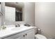 Well lit bathroom with white vanity, toilet and large mirror at 317 W Tonopah Dr # 2, Phoenix, AZ 85027