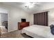 Cozy bedroom with soft carpet, a dresser, a large window and ceiling fan at 317 W Tonopah Dr # 2, Phoenix, AZ 85027