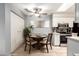 Cozy dining area with a ceiling fan, tile flooring, and an adjacent kitchen area at 317 W Tonopah Dr # 2, Phoenix, AZ 85027
