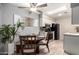 Dining area view with tile floors and white and gray backsplash in the kitchen at 317 W Tonopah Dr # 2, Phoenix, AZ 85027