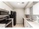 Full kitchen view featuring white cabinets, modern appliances and stylish backsplash at 317 W Tonopah Dr # 2, Phoenix, AZ 85027