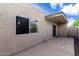 Exterior view of backyard patio, showing a door and a window for seamless indoor-outdoor living at 3345 E University Dr # 73, Mesa, AZ 85213