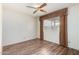 A simple, clean bedroom with wood floors, large window and brown curtains at 3345 E University Dr # 73, Mesa, AZ 85213