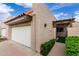 Home featuring a white garage door, terracotta roof tiles, and a private gated entrance at 3345 E University Dr # 73, Mesa, AZ 85213