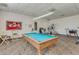 A game room contains a pool table and exercise equipment, providing lots of entertaining and fitness opportunities at 3345 E University Dr # 73, Mesa, AZ 85213