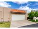 The garage features a large white door and a charming terracotta tile roof at 3345 E University Dr # 73, Mesa, AZ 85213