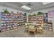 Spacious community library featuring abundant bookshelves, a table with chairs, and ample natural light from the windows at 3345 E University Dr # 73, Mesa, AZ 85213