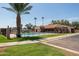 Beautiful community pool area featuring lush landscaping and ample seating for residents to relax and enjoy the outdoors at 3345 E University Dr # 73, Mesa, AZ 85213