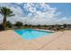 Relaxing community pool surrounded by desert landscaping and palm trees with plenty of room for residents to enjoy at 3345 E University Dr # 73, Mesa, AZ 85213