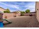 Large gravel backyard features a playset, barbecue, and young trees at 34195 N Alison Dr, San Tan Valley, AZ 85144