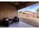 Charming covered patio with comfortable seating and a view of the well-kept backyard at 34195 N Alison Dr, San Tan Valley, AZ 85144