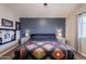 This bedroom features a unique accent wall and modern decor at 34195 N Alison Dr, San Tan Valley, AZ 85144