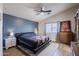 This spacious bedroom features laminate floors, ceiling fan, and modern decor at 34195 N Alison Dr, San Tan Valley, AZ 85144