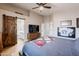 This modern bedroom features wood floors, a barn door, and access to the bathroom at 34195 N Alison Dr, San Tan Valley, AZ 85144