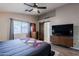 This modern bedroom features wood floors, a barn door, and stylish decor at 34195 N Alison Dr, San Tan Valley, AZ 85144