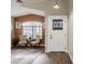 Inviting foyer featuring wood-look floors, modern lighting, and a cozy seating area at 34195 N Alison Dr, San Tan Valley, AZ 85144