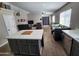 Open-concept kitchen with island seating and views of the dining and living areas at 34195 N Alison Dr, San Tan Valley, AZ 85144