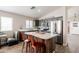 Well-lit kitchen with gray cabinets, stainless steel appliances, a kitchen island, and wood vinyl flooring at 34195 N Alison Dr, San Tan Valley, AZ 85144