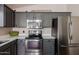 This spacious kitchen features stainless appliances, grey cabinets, and white countertops at 34195 N Alison Dr, San Tan Valley, AZ 85144