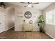 Open living area featuring wood-look floors, ceiling fan, decorative shelves and a lush house plant at 34195 N Alison Dr, San Tan Valley, AZ 85144