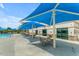 Enjoy outdoor dining by the pool with shaded tables and seating, perfect for relaxing in the sun at 34195 N Alison Dr, San Tan Valley, AZ 85144