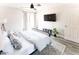 Bedroom with bed, ceiling fan, TV, decor, light-colored walls, and vinyl flooring at 3500 N Hayden Rd # 2103, Scottsdale, AZ 85251