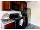Well-equipped kitchen with dark cabinets, modern appliances, and stylish countertops, great for cooking at 3500 N Hayden Rd # 2103, Scottsdale, AZ 85251