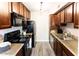 Efficient kitchen featuring modern appliances, dark wood cabinets, and sleek countertops for cooking at 3500 N Hayden Rd # 2103, Scottsdale, AZ 85251