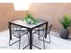 Outdoor patio showcasing a metal table and chairs, complimented by a lush green plant at 3500 N Hayden Rd # 2103, Scottsdale, AZ 85251
