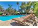 Community pool featuring cool blue water, sun loungers, and palm trees in view at 3500 N Hayden Rd # 2103, Scottsdale, AZ 85251