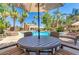 Community pool with sun loungers, seating areas, umbrellas, and lush landscaping at 3500 N Hayden Rd # 2103, Scottsdale, AZ 85251